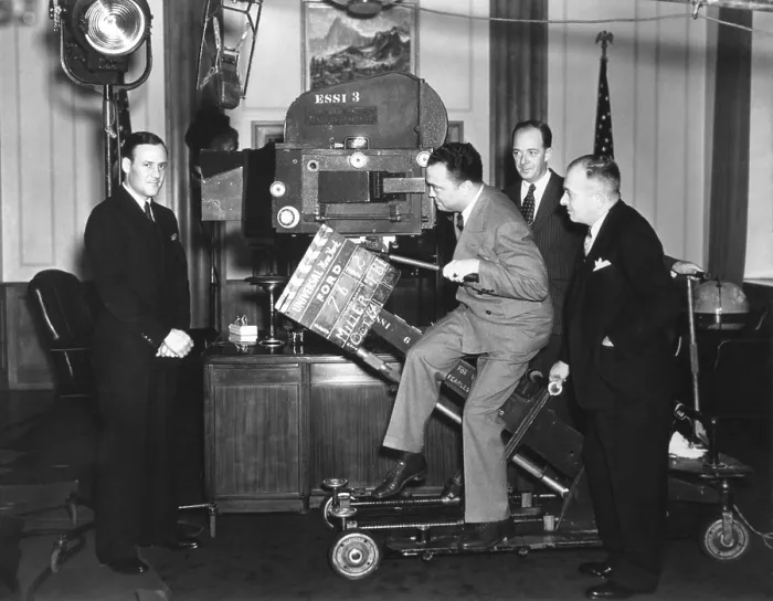 Framed Print : FBI Director J. Edgar Hoover with a Newsreel camera at Universal Studios. Clyde Tolson, Hoover's FBI colleague and personal companion is on far left. Ca. 1935-40