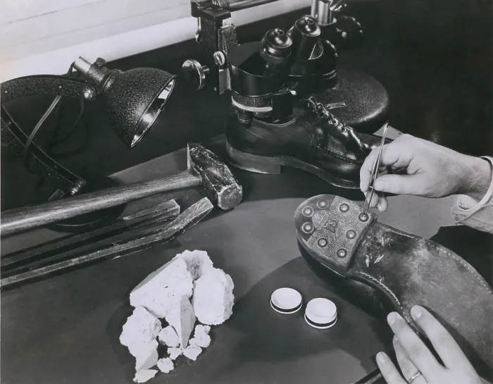 Framed Print : FBI forensic science. A technician removing safe insulation from the shoes of a burglary suspect at the FBI lab in 1954