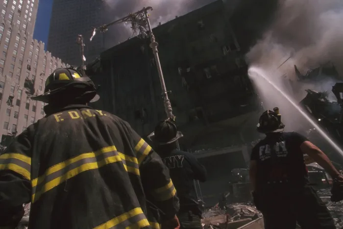 Framed Print : Fire fighter at World Trade Center site following September 11th terrorist attack. The stream water is to the still standing WTC 6