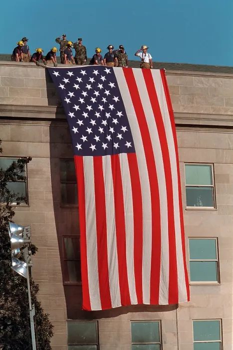 Framed Print : Firefighters hang a large American flag at the Pentagon, on the day following the Sept. 11, 2001 terrorist attack Framed Print : Firefighters hang a large American flag at the Pentagon, on the day following the Sept. 11, 2001 terrorist attack