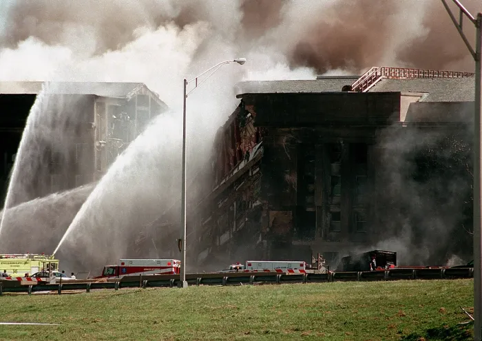 Framed Print : Firefighters struggle to contain the fire after the September 11 2001 terrorist attack on the Pentagon