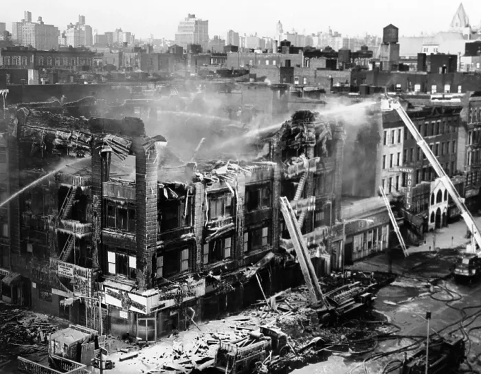 Framed Print : First act of retaliation for the assassination of Malcolm X. Firemen continue to douse the fire that destroyed Nation of Islam Mosque No