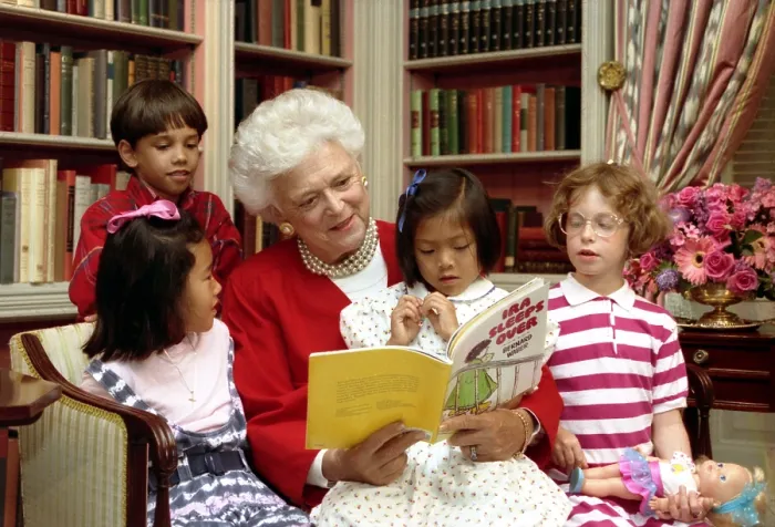Framed Print : First Lady Barbara Bush reads to children in the White House Library. As First Lady, she supported literacy programs and encouraged family reading. July 24, 1990