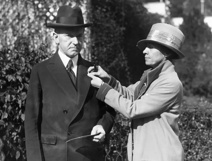 Framed Print : First Lady Grace Coolidge pins a Red Cross button on President Calvin Coolidge's coat, 1925. Courtesy: CSU Archives / Everett Collection