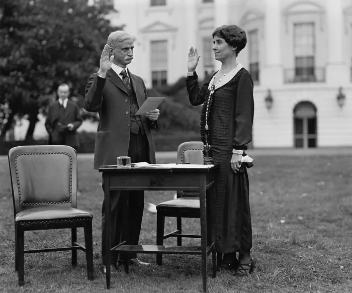 Framed Print : First Lady Grace Coolidge taking an oath before filling out her ballot for the 1924 Election. President Calvin Coolidge stands in the background. (BSLOC_2015_15_117) Framed Print : First Lady Grace Coolidge taking an oath before filling out her ballot for the 1924 Election. President Calvin Coolidge stands in the background. (BSLOC_2015_15_117)