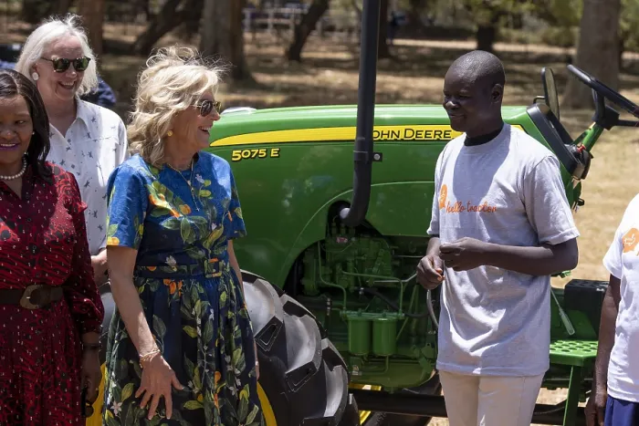 Framed Print : First Lady Jill Biden speaks with a smallholder farmer who leased farm machinery from participation in Hello Tractor, which used updated technology to facilitate tractor