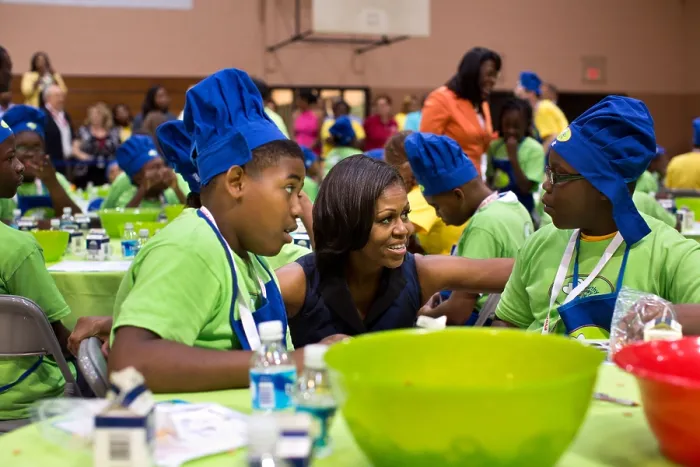 Framed Print : First Lady Michelle Obama talks with kids making trail mix at the McAlpine Park, Alabama. July 18, 2012 (BSLOC_2015_13_176)