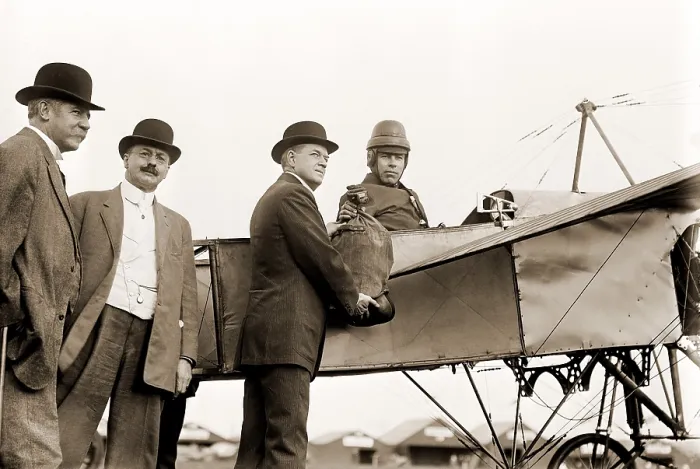 Framed Print : The first U.S. air mail pouch is handed to helmeted pilot Earle Ovington by Postmaster General Frank H. Hitchcock on Nassau Boulevard, Long Island, September 23, 1911 Framed Print : The first U.S. air mail pouch is handed to helmeted pilot Earle Ovington by Postmaster General Frank H. Hitchcock on Nassau Boulevard, Long Island, September 23, 1911