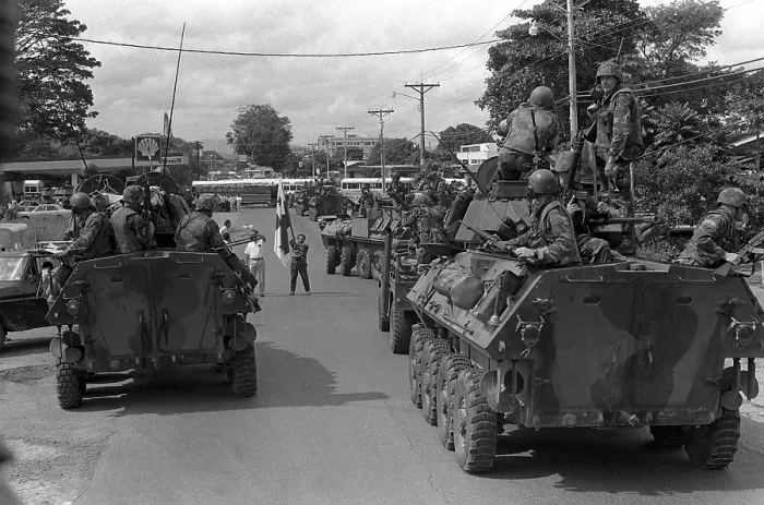Framed Print : A flag-waving supporter of Manuel Noriega halts a column of U.S. Marines on patrol in light armored vehicles outside the city of La Chorrera Panama