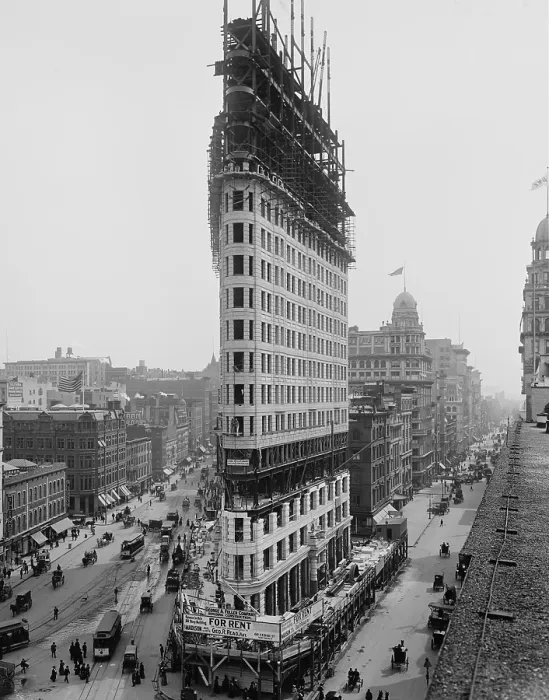 Framed Print : Flatiron Building during construction in 1902. The steel frame construction, a rectangular grid of I-beams, ascends above the stone facing