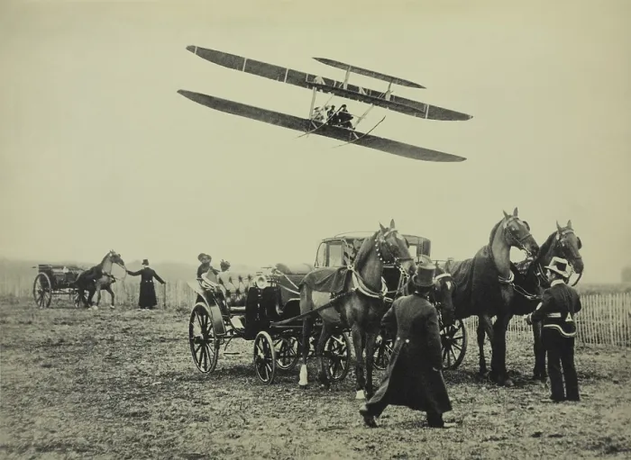 Framed Print : Flight of Wilbur Wright with his pupil Paul Tissandier, near Paris, January 1909. One the ground are coachmen and horse drawn carriages (BSLOC_2018_2_150)