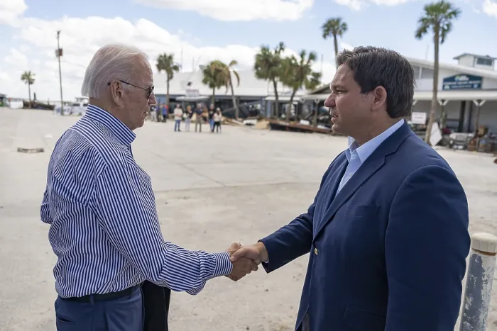 Framed Print : Florida Gov. Ron DeSantis greets President Joe Biden as he and First Lady Jill Biden arrive at Fisherman's Wharf in Fort Myers, Oct. 5, 2022