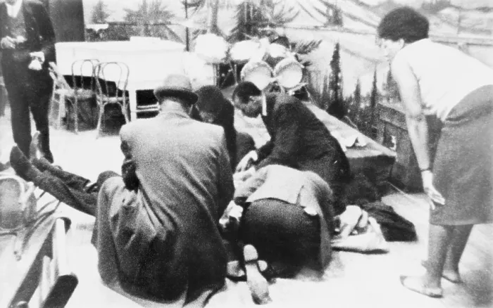 Framed Print : Followers of Malcolm X kneel by the mortally wounded Black Muslim leader on February 21, 1965