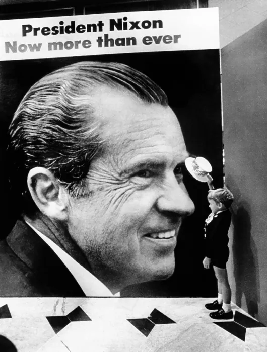 Framed Print : A four-year-old boy, tips his hat to a huge poster of President Nixon at the Fountainbleau Hotel. Above the image reads, President Nixon, Now more than ever. August 18, 1972