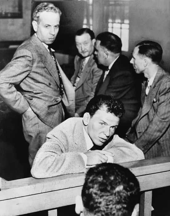 Framed Print : Frank Sinatra (1915-1998) talking with reporters during his trial for battery against journalist Lee Mortimer. Mortimer is behind Sinatra, on left side of photo. 1947 Framed Print : Frank Sinatra (1915-1998) talking with reporters during his trial for battery against journalist Lee Mortimer. Mortimer is behind Sinatra, on left side of photo. 1947