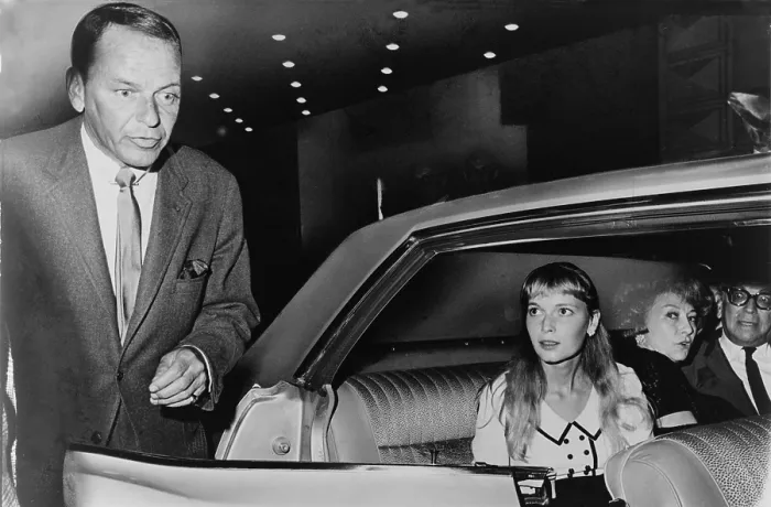 Framed Print : Frank Sinatra (1915-98) and Mia Farrow (b. 1945) prepare to leave the Schubert Theater in New York, in August 1965. The couple were married in July 1966