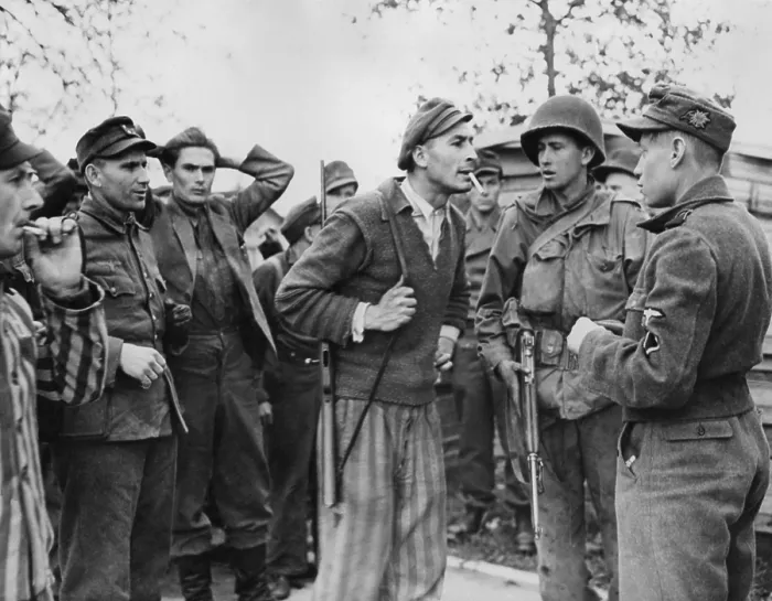 Framed Print : Freed Polish prisoner (center) of Dachau confronts a Nazi SS trooper for mistreatment of inmates
