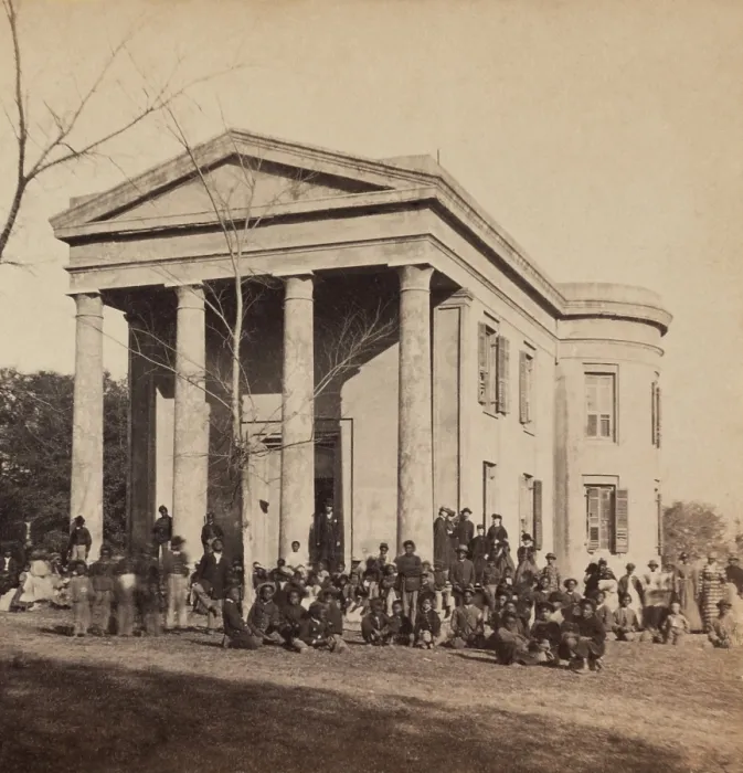 Framed Print : Freedmen and teachers in front of the Beaufort Library, South Carolina, 1862. Young African American children, and possibly the soldiers, are students