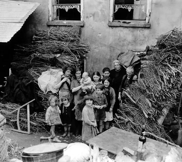 Framed Print : French family outside their home in Saint Lo, July 26, 1944. Bundles of wood cover shell holes and protected them from shrapnel. Normandy Campaign, France, World War 2