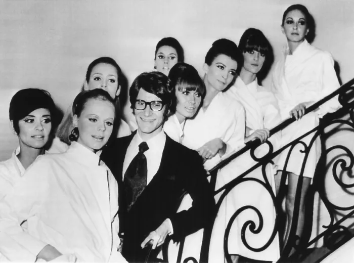 Framed Print : French fashion designer Yves Saint Laurent with models showing his 1967 spring summer collection. The models are made-up and in their smocks before the collection showing Framed Print : French fashion designer Yves Saint Laurent with models showing his 1967 spring summer collection. The models are made-up and in their smocks before the collection showing