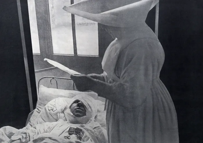 Framed Print : French nun attending a WW1 wounded soldier decorated in his hospital bed. 1916. He wears his two medals as well as a massive bandage for a head wound. (BSLOC_2012_4_63) Framed Print : French nun attending a WW1 wounded soldier decorated in his hospital bed. 1916. He wears his two medals as well as a massive bandage for a head wound. (BSLOC_2012_4_63)
