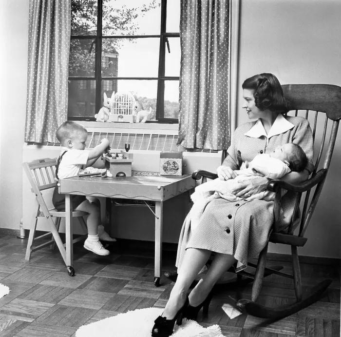 Framed Print : Future First Lady in 1952. Betty Ford holds her second son, Jack, while her eldest son Michael plays at a small table in their apartment
