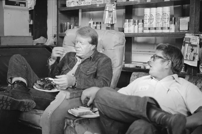 Framed Print : Future President Jimmy Carter, eats with his brother, Billy Carter, during a campaign stop at his brother's gas station in their hometown, Plains, Georgia