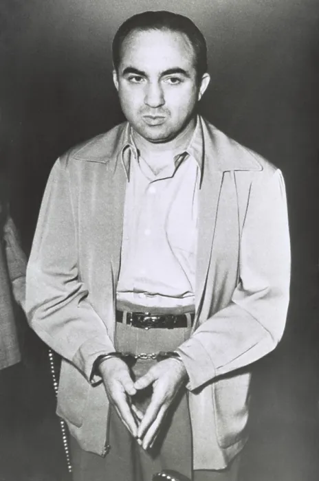 Framed Print : Gambler Mickey Cohen stands handcuffed awaiting his removal from Los Angeles Federal Court. He was sentenced to five years in prison and fined $10, 000 for income tax evasion