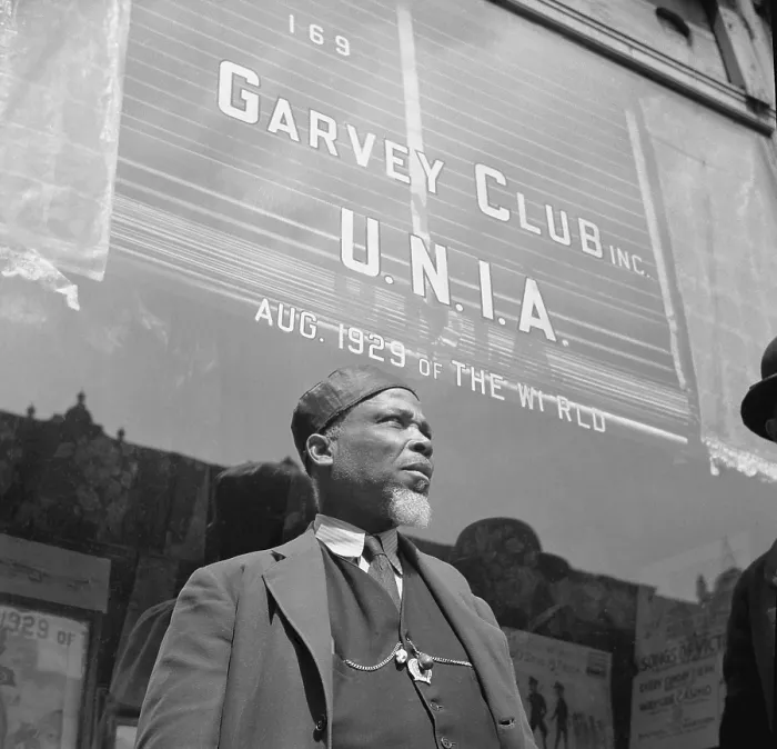 Framed Print : A Garveyite in front of the Garvey Club storefront in Harlem. U.N.I.A. (Universal Negro Improvement Association) founded by Marcus Garvey. April 1943 photo by Gordon Parks Framed Print : A Garveyite in front of the Garvey Club storefront in Harlem. U.N.I.A. (Universal Negro Improvement Association) founded by Marcus Garvey. April 1943 photo by Gordon Parks