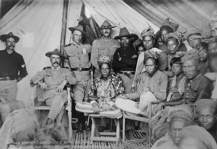 Framed Print : Gen. Samuel Sumners conference with Sultans of Bayang and Oato, at Camp Vicars, Mindanao, P.I. 1902. Capt. John Pershing, in his campaign hat, stands in center behind one Sultan