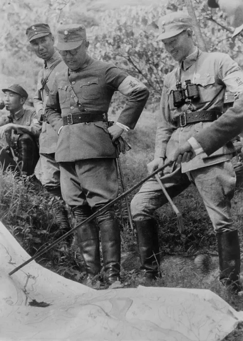 Framed Print : Generalissimo Chiang Kai-shek and other Chinese officers. They are outdoors with a map planning their next military campaign. Ca. 1937-1943. Photo by Marcus J. Clark