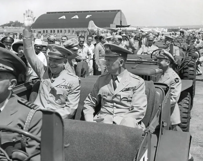 Framed Print : Generals Dwight Eisenhower and George Marshall sitting in a jeep at a Washington D.C. airport. Eisenhower is waving and smiling, contrasting with the restrained Marshall