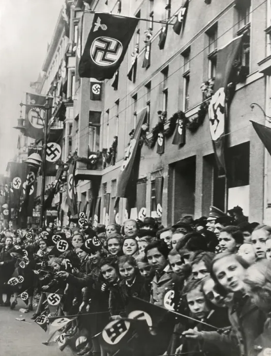 Framed Print : German children equipped with swastika flags look toward an advancing Nazi parade. Ca. 1935-1939. Unidentified location. (BSLOC_2015_13_50)