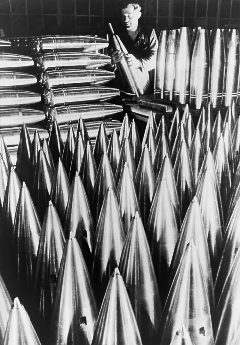 Framed Print : German munitions worker inspecting large shell casings. Ca. 1939-40. World War 2. (BSLOC_2014_10_158)