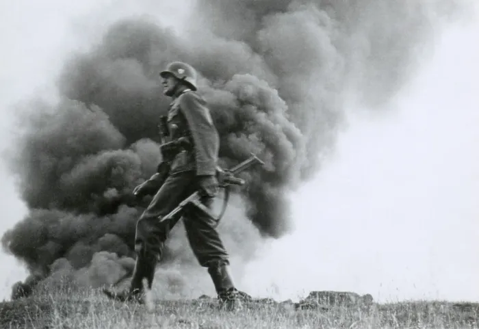 Framed Print : German officer of assault troops during the Nazi invasion of the Soviet Union, (Russia) In the Summer of 1941, the soldier strides against a background of burning buildings