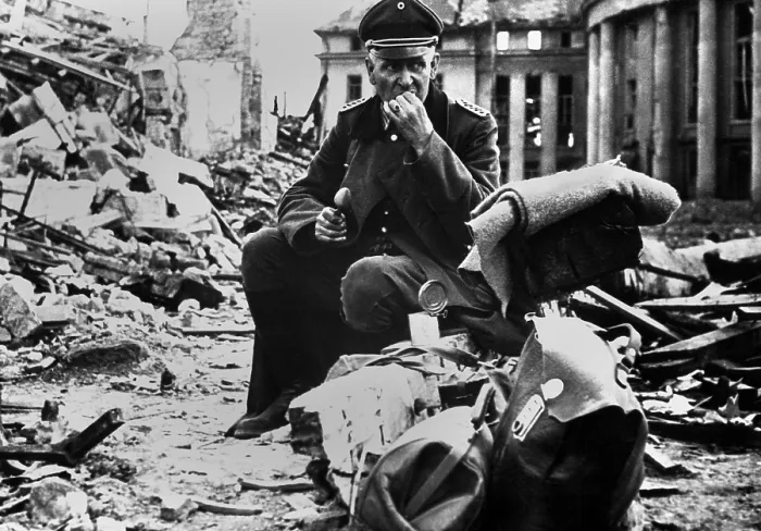 Framed Print : German Officer POW eating a can of U.S. C-rations, in the ruins of Saarbrucken. March 1945, during World War 2. (BSLOC_2013_14_295)