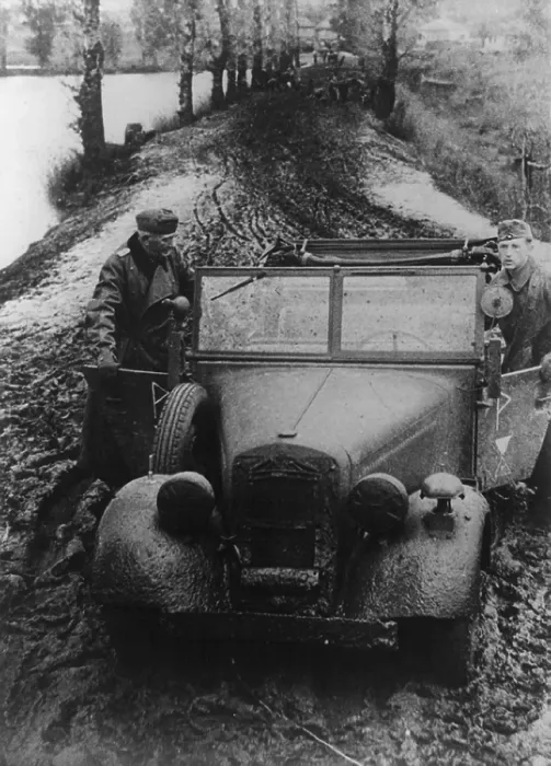 Framed Print : German soldier and officer pushing their car through Russian mud. In fall 1941, the semiannual Russian mid season slowed the German invasion into the Soviet Union. Nov. 11, 1941