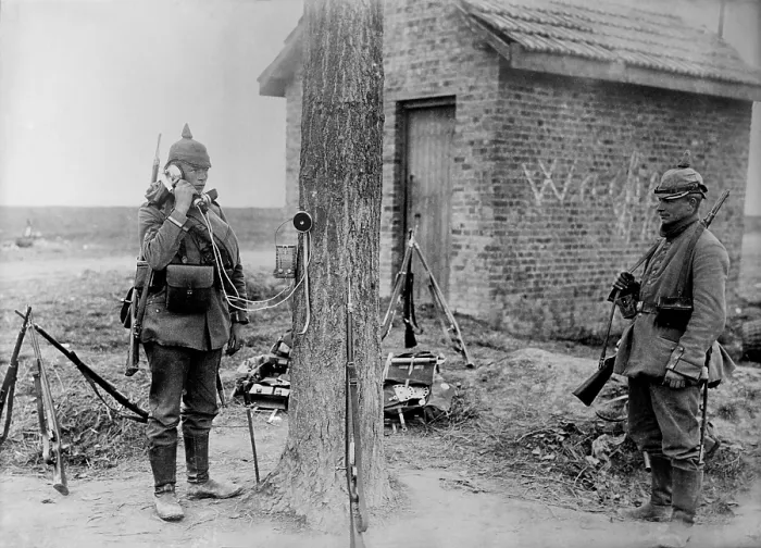 Framed Print : German soldier talking on telephone which is attached to a tree during WW1. 1914. (BSLOC_2012_4_132)