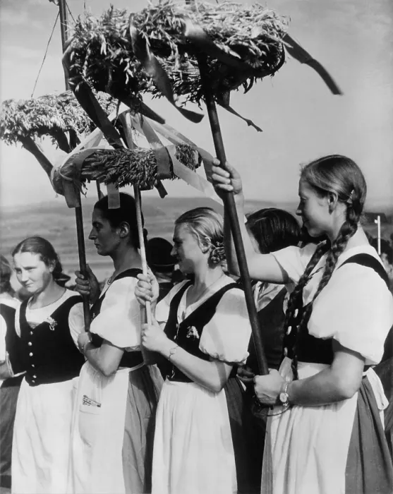 Framed Print : German women wearing traditional folk costumes during the 1935 Erntedankfest. Peasant women hold beribboned wreaths with during the Nazi celebration. (BSLOC_2013_11_22)
