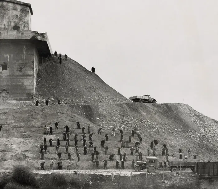 Framed Print : German workers covering a massive anti-aircraft bunker built in Berlin during World War 2. Both men and women are at work. March 4, 1951. (BSLOC_2014_13_14)