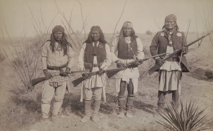 Framed Print : Geronimo, standing on the right, holding a long rifle, with a son and two warriors, each holding rifles. Photo by C. S