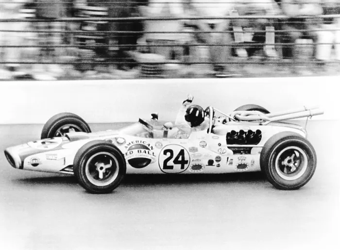 Framed Print : Graham Hill, waves as his car streaks toward the finish line to win the Indianapolis 500. May 30, 1966
