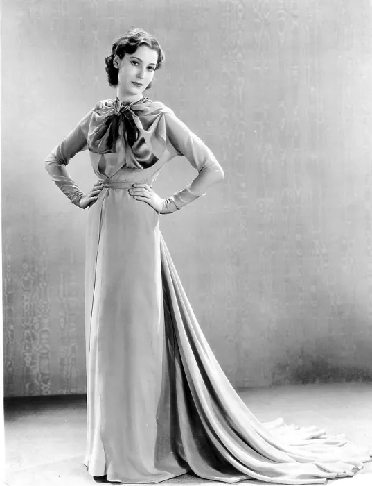 Framed Print : THE GREAT IMPERSONATION, Valerie Hobson, in a rose-colored tea gown with satin bands, by Vera West, 1935