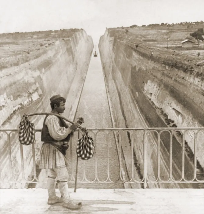Framed Print : Greek man in traditional costume on a bridge over the Corinth Canal built between 1881 and 1893