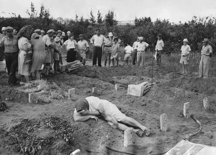 Framed Print : A grief stricken mother lying on the grave of her Haganah soldier son. Near Tel Aviv, July 31, 1948