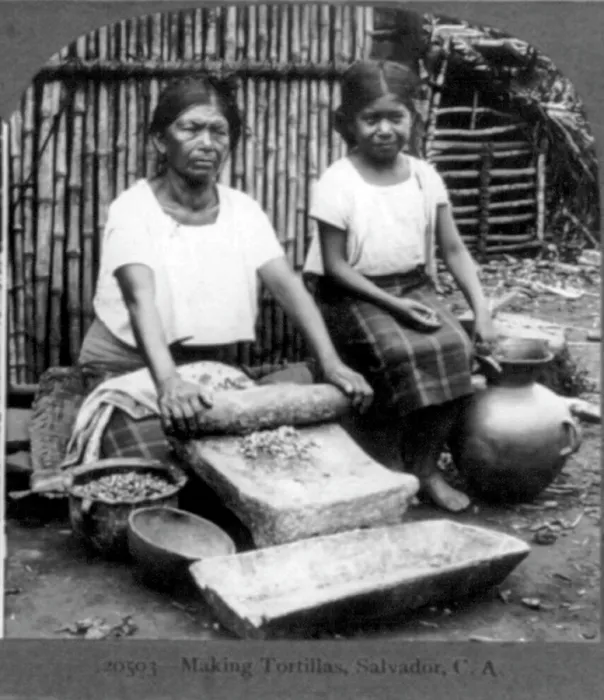 Framed Print : Grinding corn for tortillas with a metate in the streets of Guadalupe, Mexico. 1902