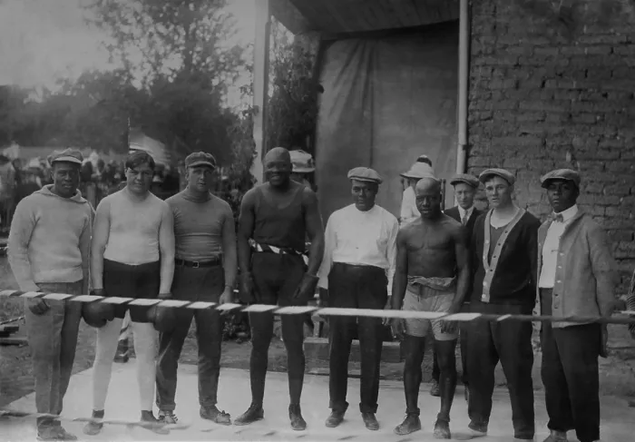 Framed Print : Group portrait of boxer Jack Johnson, Heavy Weight Champion, at his training camp, 1910-15. L-R: Perkins; Marty Cutle; J. Debray; Jack Johnson; W. Burns; C