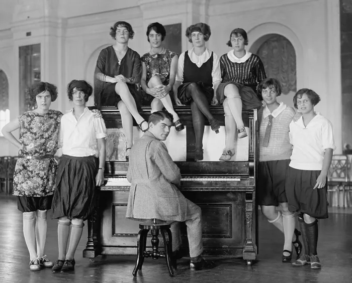 Framed Print : Group of young women described as Debutantes wearing bloomers around a man at a piano. Oct 8, 1923. Washington, D.C. vicinity, (BSLOC_2015_17_209)