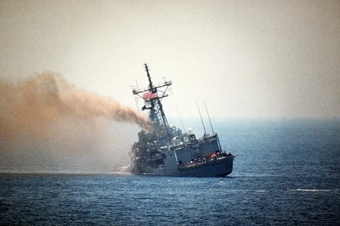 Framed Print : Guided missile frigate USS STARK listing to port after being struck by an Exocet missile launched from an Iraqi jet killing 37 sailors and injuring 21 were