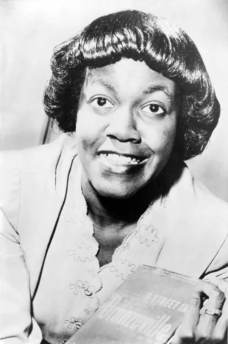 Framed Print : Gwendolyn Brooks (1917-2000) holding her book, 'A Street in Bronzeville, ' her first book of poetry published in 1945